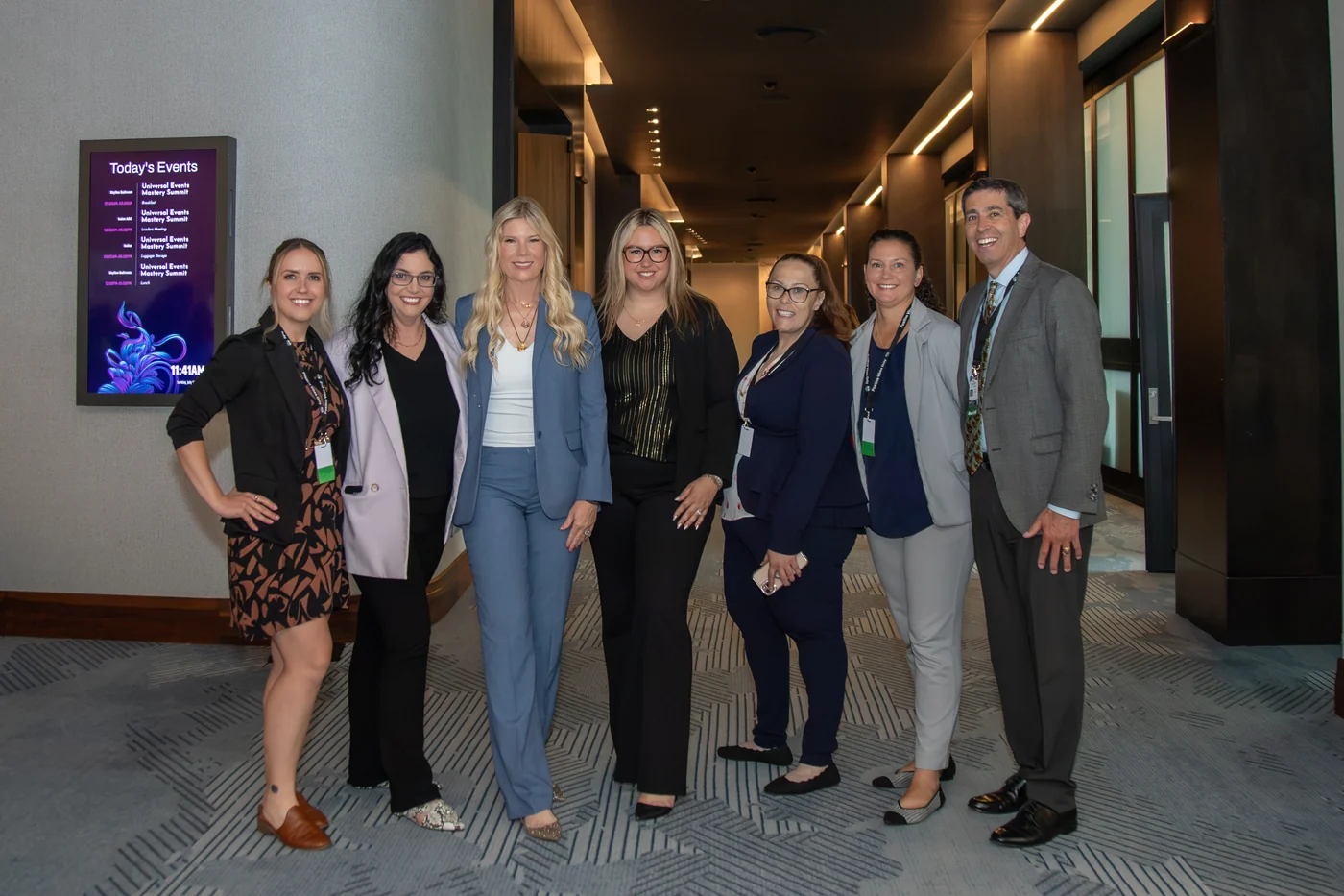 Universal Events team members together in the hallway at the Mastery Summit